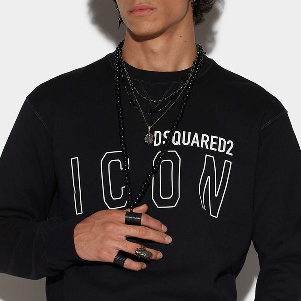 Man with black sweatshirt with dsquared2 icon logo on his chest and long necklaces