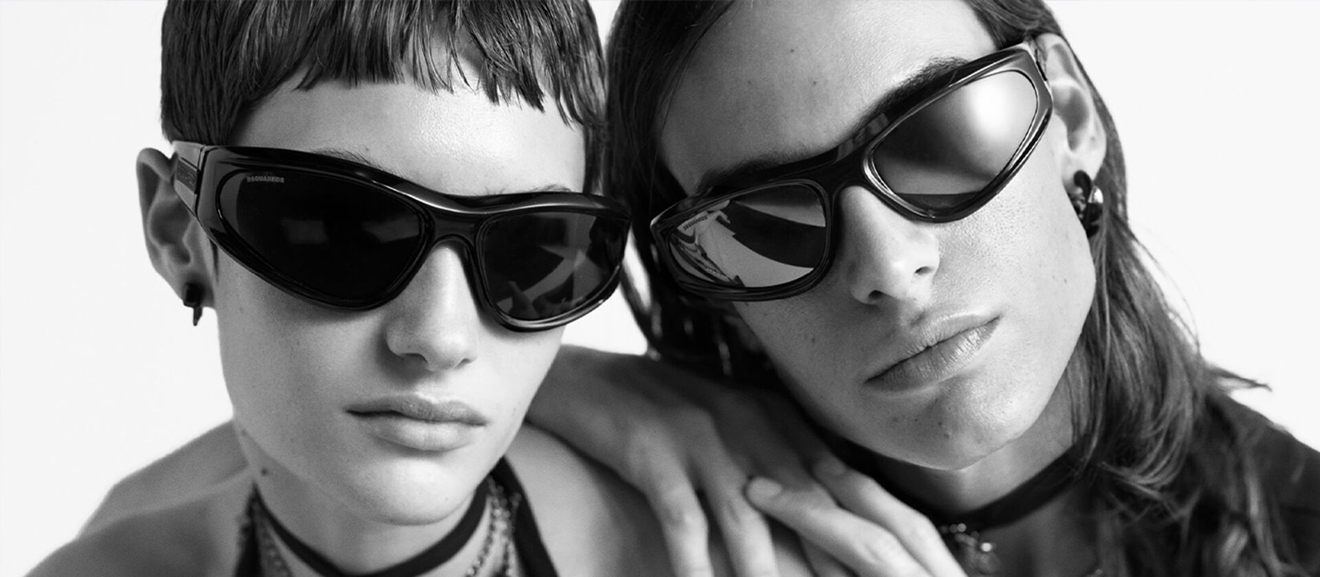 man & woman with black sunglasses on black and white background
